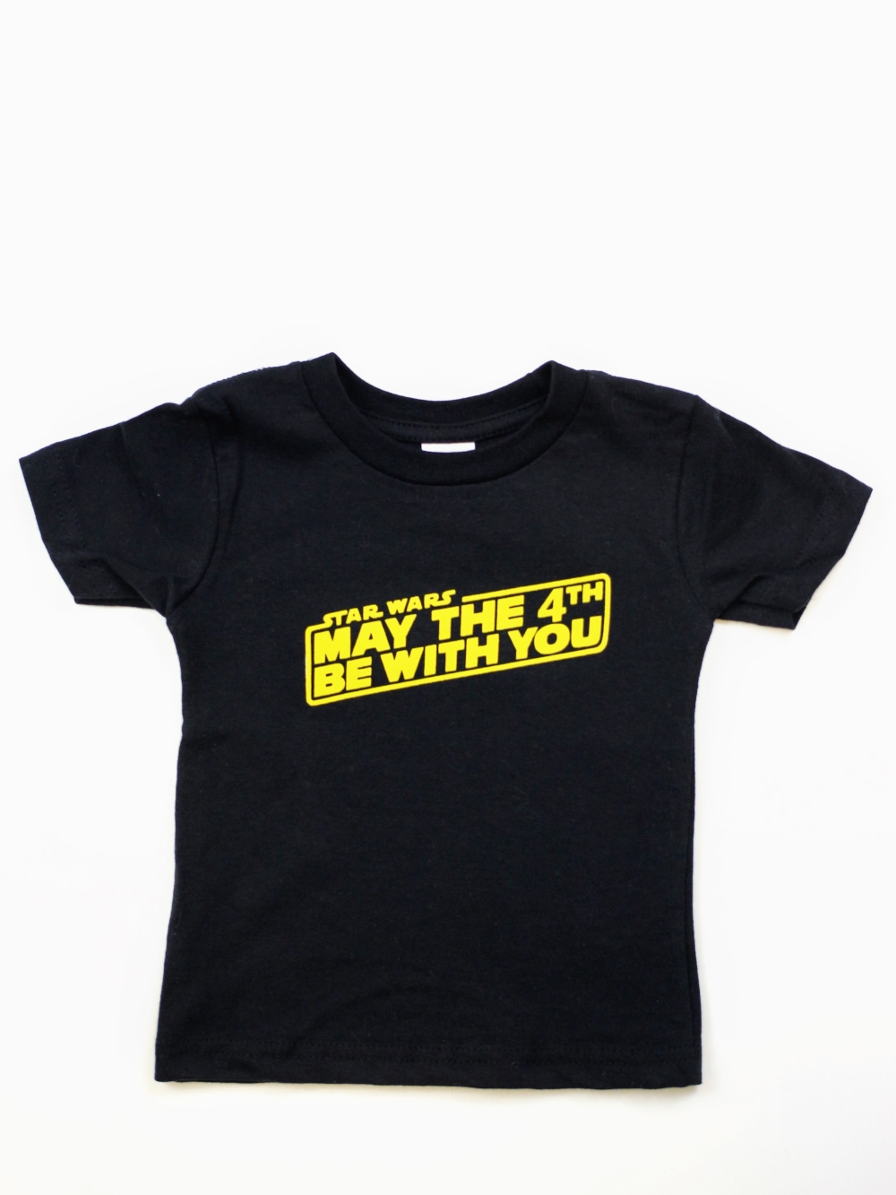 Get ready to celebrate Star Wars day with this DIY May The 4th Be With You t-shirt. Make your own t-shirt for under $5. Click through to see the steps so you can make one too!