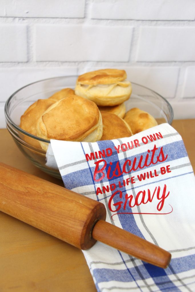 Click here to see how to make this DIY "Mind Your Own Biscuits" Kitchen Towel with heat transfer vinyl. From Polka Dotted Blue Jay and Craftables
