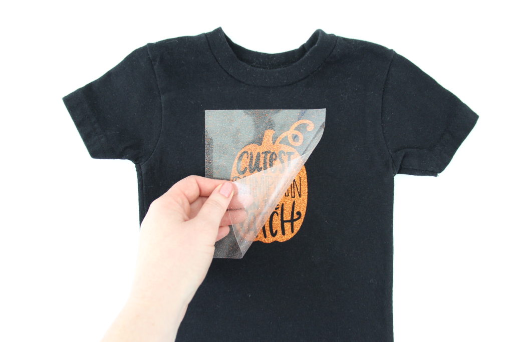 Make a "Cutest Pumpkin in the Patch" t-shirt for your kiddo with a plain t-shirt and glitter heat transfer vinyl in less than 10 minutes with this easy DIY.