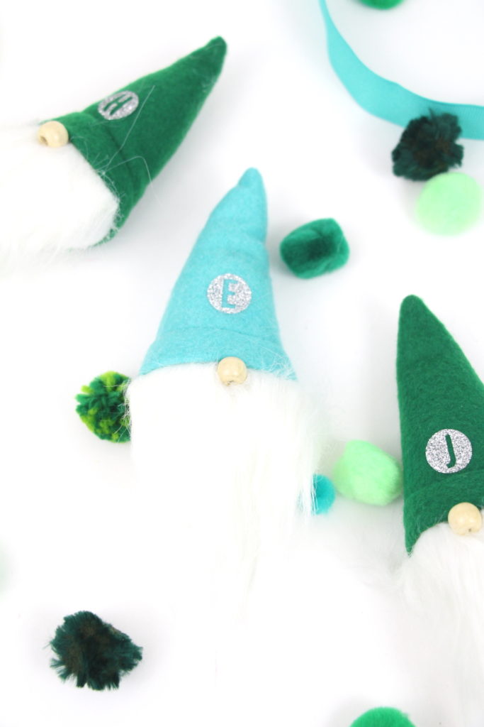 This year I am loving mint and green together with a tiny bit of pink and found these gnomes that were too cute to pass up. Keep reading to see how I made my Monogrammed Gnomes for Christmas Stockings.