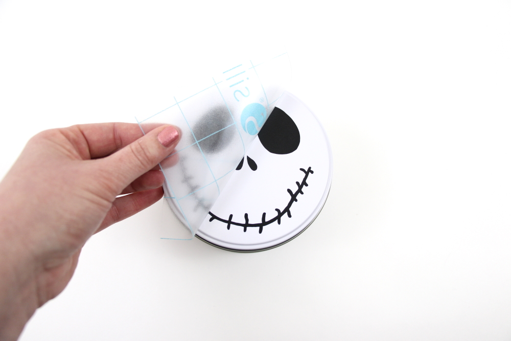 This Jack Skellington cookie tin is an easy craft to make for Halloween. Make using free cut file and adhesive vinyl.