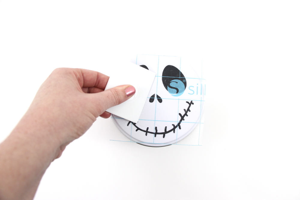 This Jack Skellington cookie tin is an easy craft to make for Halloween. Make using free cut file and adhesive vinyl.