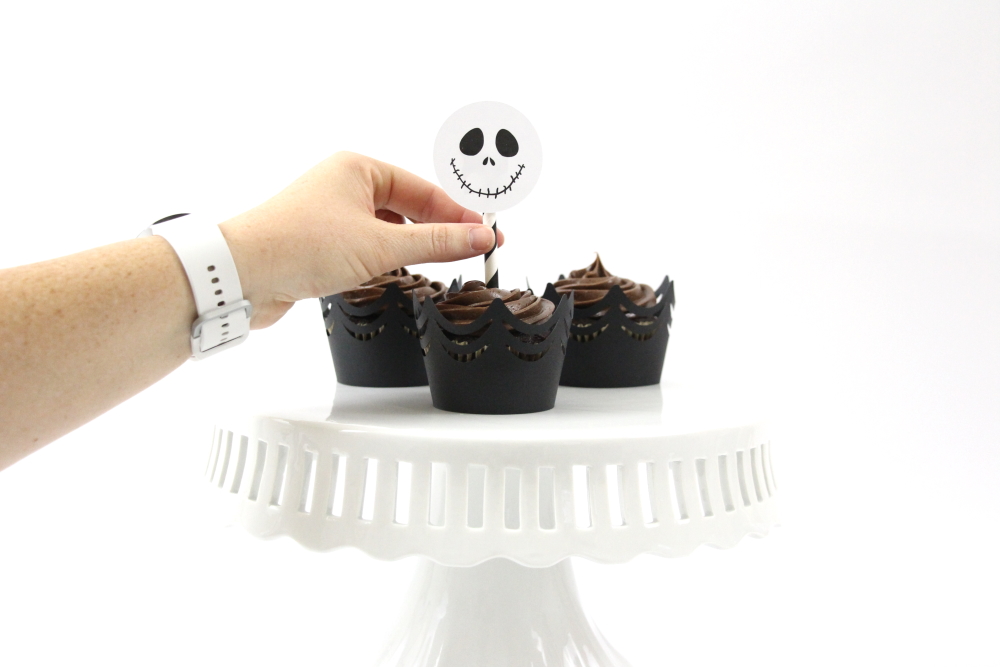 Dress up store-bought cupcakes with these DIY Jack Skellington Cupcake Toppers with a free SVG and the print and cut features in the Silhouette Software.