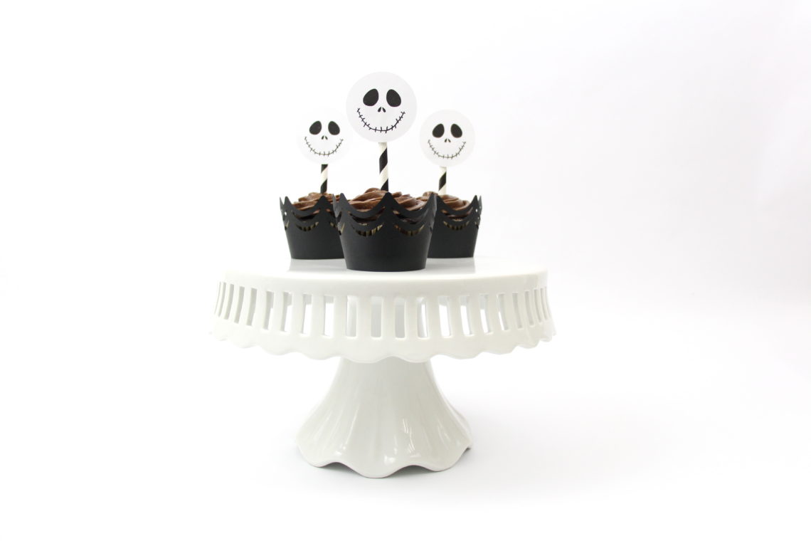 Dress up store-bought cupcakes with these DIY Jack Skellington Cupcake Toppers with a free SVG and the print and cut features in the Silhouette Software.